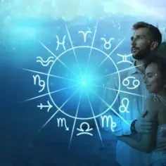 Para, przytuleni na tle nieba, z kręgiem znaków zodiaku. 3 października znak zodiaku to Waga, symbol harmonii i równowagi.