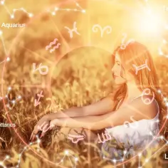 Kobieta w polu pszenicy, otoczona znaki zodiaku. Sprawdź swój horoskop na jutro skorpion i odkryj przyszłość.