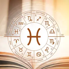 Koło zodiaku z symbolem Ryb w centrum. 8 marca znak zodiaku to Ryby, symbolizujące intuicję i empatię.