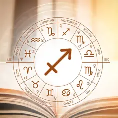Koło zodiaku z symbolem Strzelca, znaku zodiaku 4 grudnia, na tle otwartej księgi.