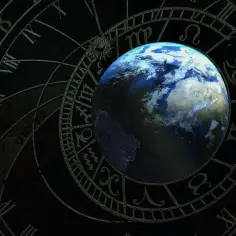 Ziemia na tle koła zodiaku. 8 maja znak zodiaku to Byk, symbolizujący stabilność i siłę.