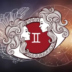 Znak zodiaku Bliźnięta, symbolizowany przez dwie twarze i symbol "II", otoczony kryształami i kołem zodiaku.