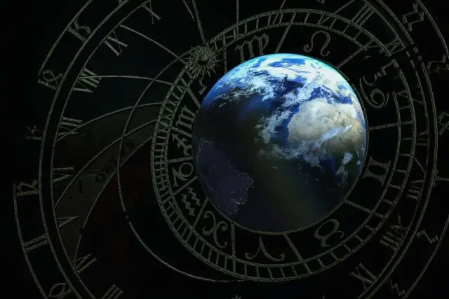 Ziemia na tle koła zodiaku. 8 maja znak zodiaku to Byk, symbolizujący stabilność i siłę.